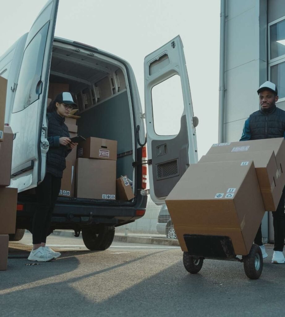 Our Man And Van movers carrying boxes into a new flat