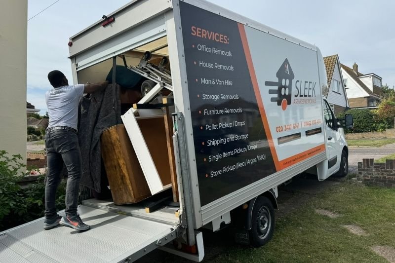 Sleek Assured Removals worker oing Loading Van in West London